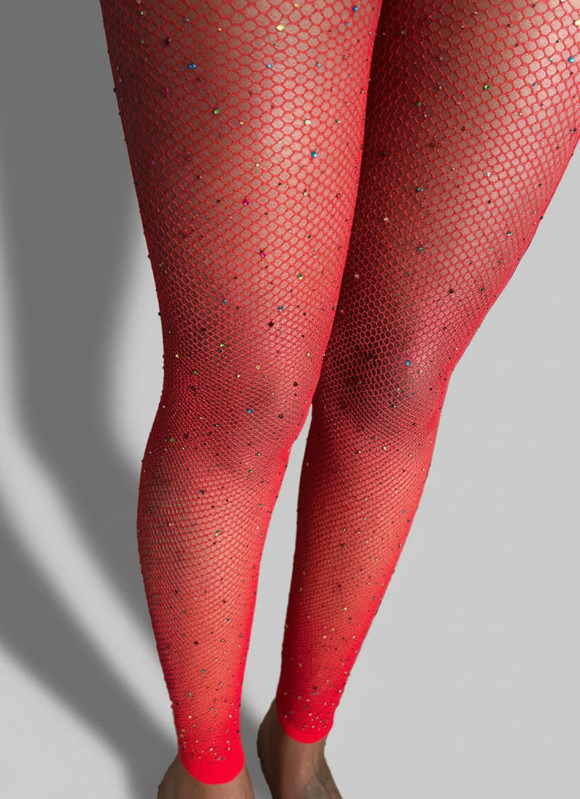 Red fishnet stockings close-up on legs with a grey background 
