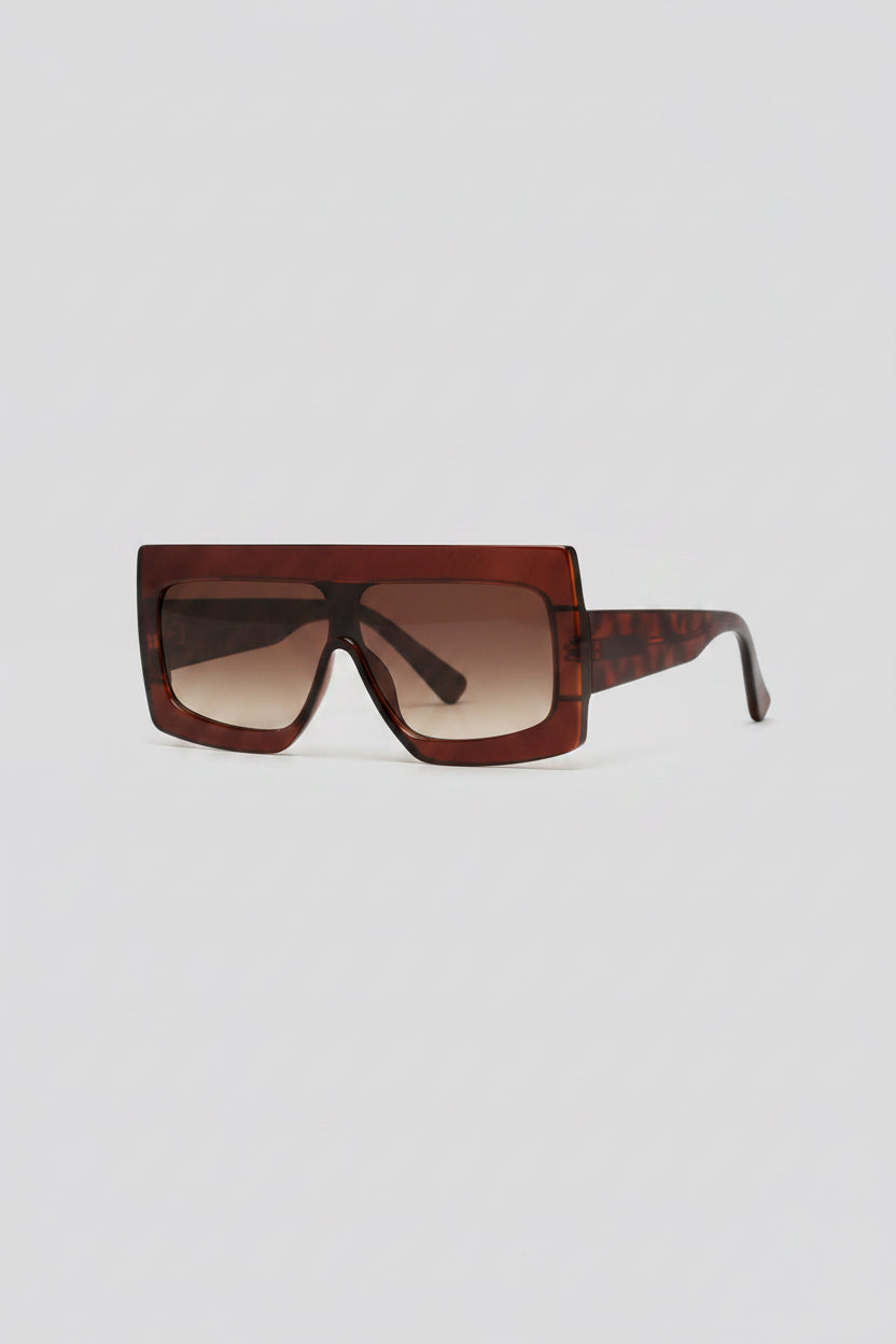 Brown sunglasses with a thick rectangle frame on a neutral background