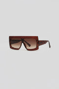 Brown sunglasses with a thick rectangle frame on a neutral background