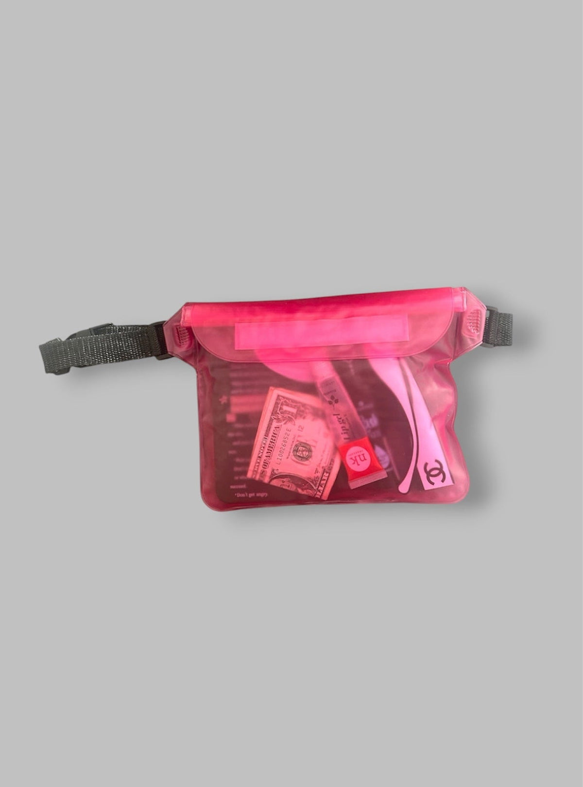 Pink transparent waist bag with money and a phone on a gray background