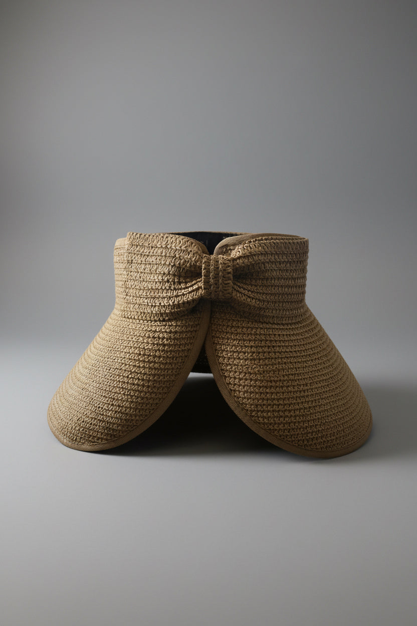 Back view of straw brim visor on a gray background