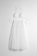 Full-length view of the voluminous Isabella tulle maxi skirt by eau archives pared with a white bikini top