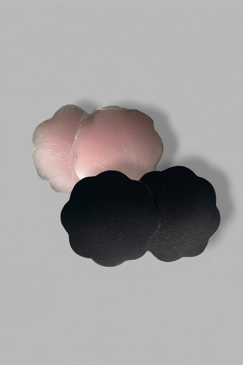 Two pairs of silicone breast adhesives on a light gray background 