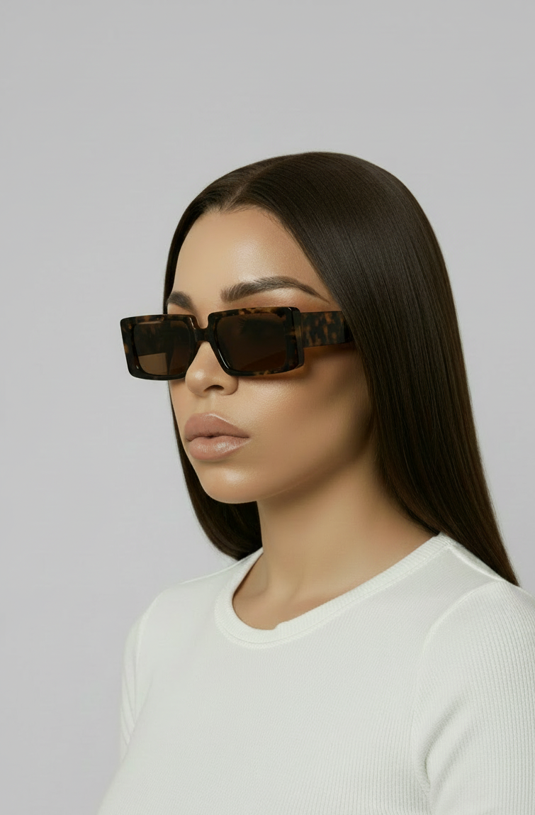 Model with tortoiseshell glasses and a white baby tee